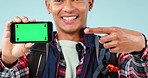 Hiking, green screen and phone with hand pointing by man face in studio with perfect review on blue background. Travel, space and portrait of guy backpacker show location, search or app guide support