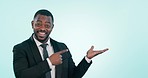 Business man, pointing and palm in studio for choice, advertising and a blue background. Professional black male person with hand for mockup, suggestion or offer for deal and solution or portrait