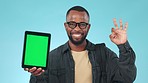 Tablet mockup, green screen and black man with advertising, OK with app and pointing at ads on blue background. Tracking marker, social media with promotion or agreement, marketing and blog in studio