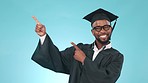 Pointing, happy and face of man graduate in a studio with mockup space for marketing or advertising. Smile, pride and African male university student showing mock up isolated by blue background.