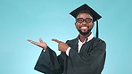 Pointing, mockup and face of man graduate in a studio with empty space for marketing or advertising. Happy, smile and African male university student showing mock up isolated by blue background.