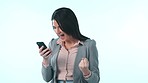 Business woman, phone and success in studio for winning, celebrate profit and bonus promotion on blue background. Happy worker, achievement and surprise with fist for mobile deal, reward and prize 