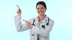 Studio woman, smile and doctor pointing at medical information, hospital commercial or medicine promotion. Mockup space, healthcare portrait and cardiology expert, nurse or surgeon on blue background