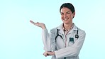 Doctor, happy studio woman and palm gesture for medical info, hospital promo or medicine product placement. Mockup space, clinic portrait and cardiology expert, nurse or surgeon on blue background