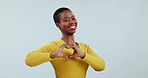 Heart, hands and face of black woman in studio for kindness, wellness or charity donation on white background. Portrait of happy model with love icon, hope and thanks for support, emoji sign or peace