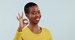 Okay, hands and face of woman in studio for vote, certified review or feedback on white background. Portrait, happy african model and sign of excellence for success, like emoji or yes icon of support