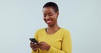 Woman, smile or typing on smartphone in studio, scroll social media or reading funny notification of contact on white background. Happy african model download digital app, mobile games or search meme