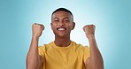 Black man, success and fist pump, excited about winning competition or lotto with mockup space on blue background. Happiness, cheers and yes, reward or bonus for contest with achievement in studio