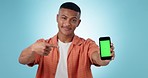 Green screen phone, studio man and point at online sales discount, web promotion or media commercial. Cellphone, brand logo design and portrait of person with mockup graphic space on blue background