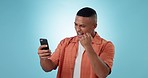 Studio phone, fist pump celebration and man reading news, giveaway announcement or competition success deal. Smartphone app, winner achievement and excited person celebrate results on blue background