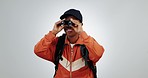 Tourist, backpacker and woman with binocular in studio for travel adventure. Surprise, search or black person with backpack for hiking, gear and sightseeing holiday or vacation on a white background