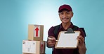 Box delivery, happy man and studio clipboard for logistics courier, product shipping or export service signature. Person, portrait and offer supply chain, invoice or sign paperwork on blue background