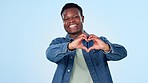 Heart, hands and face of black man in studio with thank you, hope or love gesture on blue background. Hope, emoji and portrait of African male model with finger frame for gratitude, kindness or care