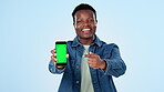Man, laughing and phone green screen for marketing mockup, video presentation or speaking of opportunity in studio. Face of african person pointing to mobile app, tracking markers and blue background