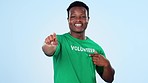 Pointing, black man and volunteer with welcome for charity, community work and help. Happy, face portrait and African person with a gesture and communication for volunteering on a studio background