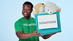Man, face or donation or box for charity in studio community service, social responsibility or toys. African person, volunteer or portrait gift nonprofit package kindness, outreach on blue background