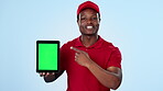 Delivery guy, green screen or black man with tablet pointing for ecommerce to track online shopping. Studio, face or happy courier talking about mockup space for stock distribution on blue background