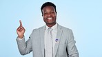 Face, hand pointing and black man in studio with vote, information or promo on blue background. Government, politics and portrait of African male politician show news, checklist or sign up platform