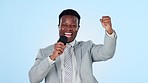Black man, microphone and reporter with broadcast and cheers, excited journalist with success and fist pump on blue background. Game show commentator, hosting celebration and win in media in studio