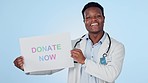 Happy black man, doctor and sign for donation, charity or community service against a studio background. Portrait of African male person in medical healthcare with billboard or poster to donate now