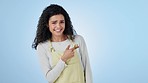 Face, waitress and woman with promotion, pointing and announcement on a blue studio background. Portrait, barista and model with hand gesture, review and feedback with option, decision and choice