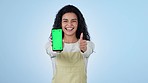 Woman, phone green screen and thumbs up for marketing, subscription and study or learning opportunity in studio. Face of excited student pointing to mobile app and tracking markers on blue background