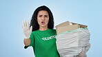 Woman, volunteering and thumbs up for garbage, green and activism for litter, sustainability and clean. Climate change, plastic and blue studio background for pollution, recycle and accountability
