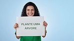 Volunteer, poster and woman plant trees in studio isolated on a blue background mockup space. Portrait, sign for ecology and earth day, climate change and excited or happy person protect environment