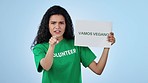 Volunteer woman, vegan sign and studio for smile on face, search and point at you by blue background. Recruitment, diet choice and call to action for sustainable food, poster or ecology in Barcelona
