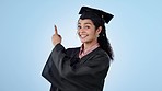 Graduation, happy or student pointing to education, college or university presentation for offer. Smile, woman or excited face of graduate in studio for scholarship or discount on blue background 