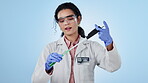 Face, woman and scientist with vaccine, test tube and healthcare on a blue studio background. Portrait, medical professional and scientist with vials, lab equipment and experiment with healthcare