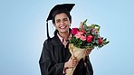 Graduation, flowers and smile with a woman student on a blue background in studio to blow a kiss for success. Portrait, education and a happy young university graduate saying thank you at a ceremony