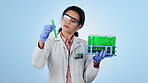 Science, research and sample with a doctor on a blue background in studio for breakthrough innovation. Medicine, solution or test tube vial with a young woman holding vaccine, cure or treatment