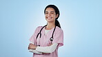 Nurse, face and confidence in studio smile for customer trust, welcome or professional help mockup. Female person,  crossed arms and scrubs or stethoscope healthcare clinic, pride on blue background