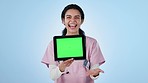 Doctor, woman and tablet green screen for healthcare presentation, information or advice in studio. Face of medical student or excited nurse with digital mockup or telehealth space on blue background