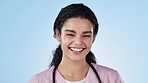 Face, woman and nurse, healthcare and smile with expert medical professional on blue background. Headshot, portrait and pride with happiness. caregiver and health worker, help and trust in studio
