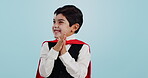Choice, halloween and excited child in costume ready for event, hungry and isolated in a studio blue background. Option, checklist and funny young kid with comedy, joy and happiness for holiday
