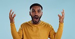 Wow, face and man with mind blowing news in studio with shocked, gesture or expression on blue background. Surprise, portrait and male model with hand emoji for unexpected deal, announcement or info