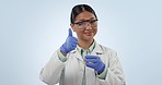 Science, thumbs up and smelling instructions with a woman in studio on a blue background for chemical experiment. Portrait, smile and success with a happy young asian scientist showing you how to