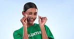 Wink, volunteer and face of a woman on a studio background with glasses while working. Flirty, happy and portrait of a young charity employee with eyewear, laughing and an entrepreneur smile