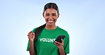 Excited woman, phone and volunteer with fist pump for winning or good news against a studio background. Portrait of happy person smile in celebration with mobile smartphone for achievement or bonus