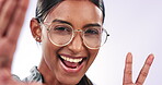 Selfie, peace sign and glasses with the face of an indian woman in studio on a white background closeup. Portrait, smile and social media with a happy young person posing for a profile picture