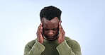 Black man, pain and headache in studio for stress, crisis and mental health on blue background. Frustrated model massage temple with anxiety, brain fog and tired of migraine, depression and vertigo 