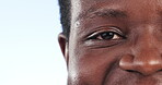 Closeup, man and eye with vision, mockup space or clear sight on a blue studio background. African person, face or model with wellness, eyelashes or looking with optometry, portrait or contact lenses