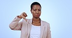 Thumbs down, business woman and face with opinion and negative vote in a studio. Portrait, female professional and sad with fail and emoji hand sign with feedback and wrong with blue background