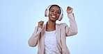 Black woman, dance and listening to music at work with happiness on blue background in studio. Employee, dancing and hear radio, hip hop or techno sound in headphones with freedom or excited energy
