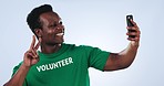 Volunteer, happy black man or selfie pose for studio charity website, community service blog or NGO social media. Cellphone photography, peace sign or activist post profile picture on blue background