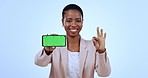 Face, business and black woman with smartphone, ok sign and feedback on a blue studio background. Portrait, African person and worker with a cellphone, employee and tracking markers with like or icon