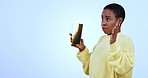 African woman, popcorn and surprise in studio, shock and fear with mockup space by blue background. Girl, cinema or theater for eating corn snack to watch thriller movie, film or horror with mess
