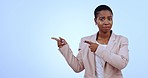 Surprise, no and black woman in studio pointing for bad news, announcement or information. Advertising, professional and portrait of business person with hand gesture for promotion on blue background